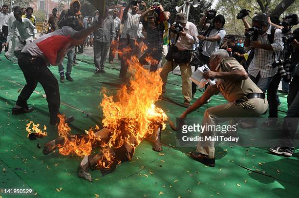 Tibetan man screams as he runs engulfed in flames after self-immolating at a protest in New Delhi, India, ahead of Chinese President Hu Jintao's...