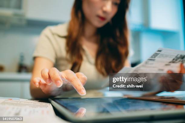 upset woman thinking about high prices while looking at utilities, gas, electricity, rental charges, planning personal budget while sitting in kitchen. - lagförslag bildbanksfoton och bilder