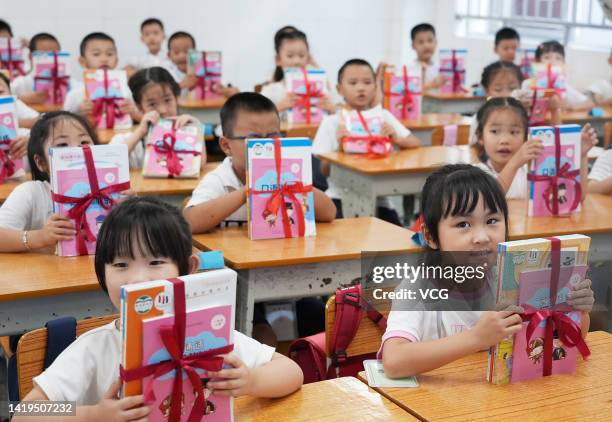 Students receive their new textbooks as new semester begins on August 28, 2022 in Guilin, Guangxi Zhuang Autonomous Region of China.