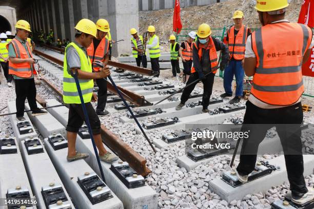 People lay tracks on the high-speed railway linking Fuzhou and Xiamen on August 30, 2022 in Xiamen, Fujian Province of China. As China's first...