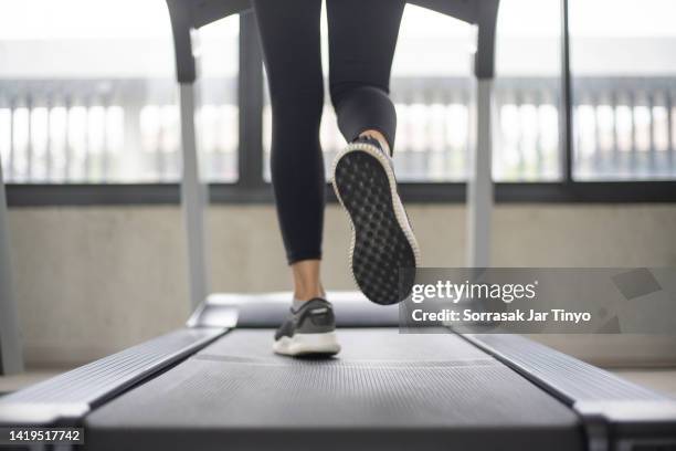 women legs running on treadmill at the fitness gym. - トレッドミル　女性 ストックフォトと画像