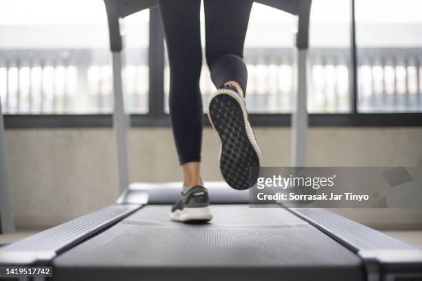 women legs running on treadmill at the fitness gym. - walking feet stock pictures, royalty-free photos & images