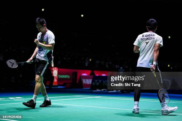 Mohammad Ahsan and Hendra Setiawan of Indonesia react in the Men's Doubles First Round match against Kang Min Hyuk and Seo Seung Jae of Korea during...