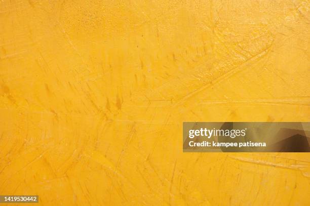 a background of a plain yellow wall - grainy wall stock pictures, royalty-free photos & images