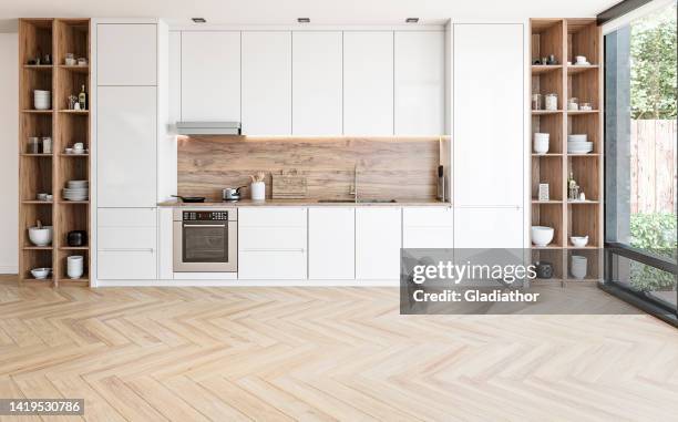 modern white kitchen with rectangular breakfast kitchen island with stools - parket stockfoto's en -beelden