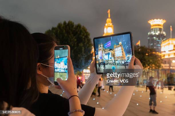 In this photo illustration, buildings at The Bund are shown on a tablet with an urban digital twin app ahead of the 5th World Conference on...
