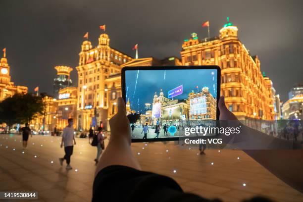 In this photo illustration, buildings at The Bund are shown on a tablet with an urban digital twin app ahead of the 5th World Conference on...