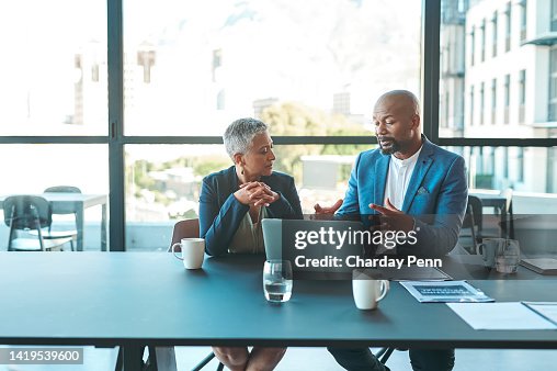 Business, presentation and man on a laptop in a corporate conference or office collaboration with a woman at work. Businessman, manager or coach for marketing, strategy and sales working with CEO. Business, presentation and man on a laptop in a corporate conference or office collaboration with a woman at work. Businessman, manager or coach for marketing, strategy and sales working with CEO.