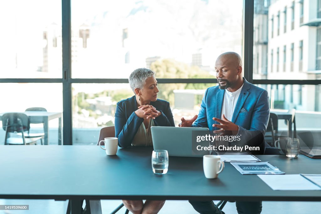 Business, presentation and man on a laptop in a corporate conference or office collaboration with a woman at work. Businessman, manager or coach for marketing, strategy and sales working with CEO.