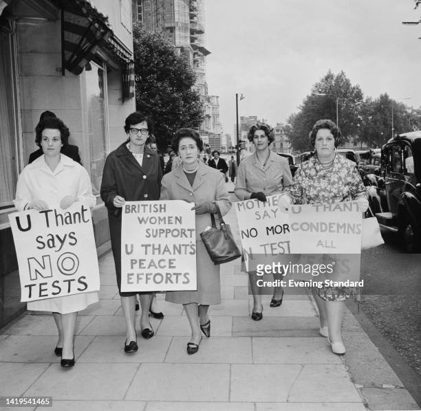 Five woman, four holding placards , in support of the peace plan proposed by United Nations Secretary General U Thant, United Kingdom, 9th July 1962....