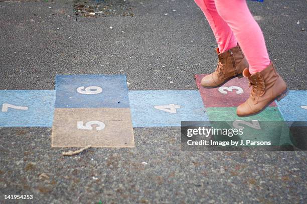 girl playing hop scotch - school playground stock-fotos und bilder