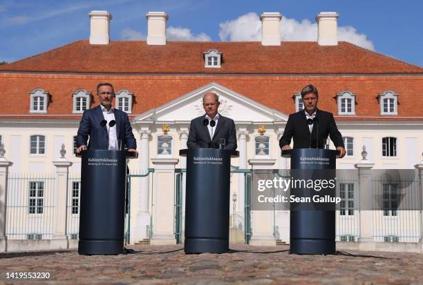 German Chancellor Olaf Scholz , Finance Minister Christian Lindner and Economy and Climate Action Minister Robert Habeck speak to the media at the...
