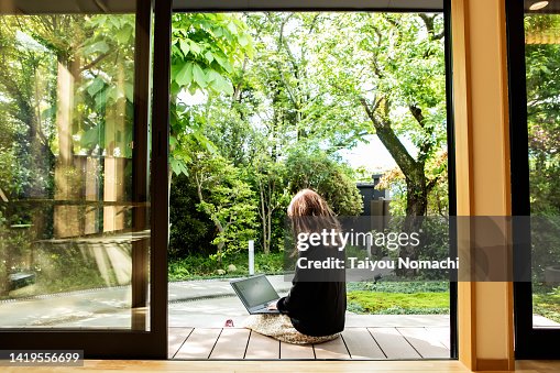A female guest working on the porch of the guesthouse where she stayed during her trip to Japan. A female guest working on the porch of the guesthouse where she stayed during her trip to Japan.