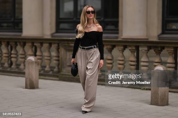 Isabelle Hartmann is seen wearing Bottega Veneta mini Jodie black leather bag, Saint Laurent black silver heels, Edited x Isabelle Hartmann wide leg...