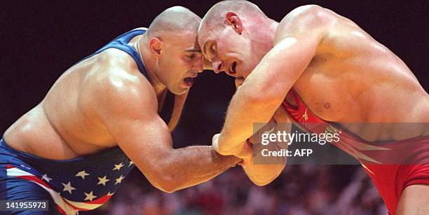 Russian Alexander Karelin and Matt Ghaffari of the US are locked head to head during their Olympic super heavyweight Greco-Roman wrestling final 23...