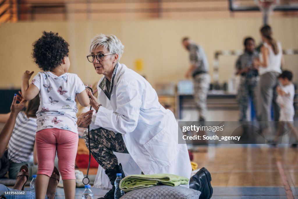 Army doctor with civilians after natural disaster