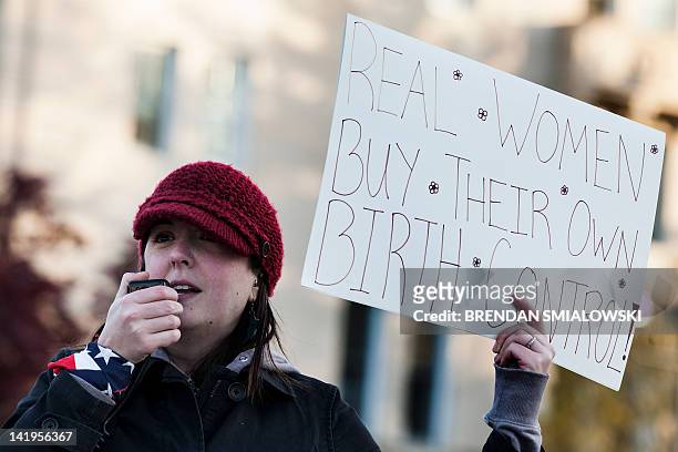 Keli Carenser, a Tea Party supporter from Seattle, Washington, holds a sign as she protests recent health care reform legislation outside the US...