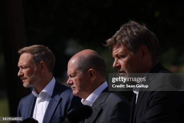 German Chancellor Olaf Scholz , Finance Minister Christian Lindner and Economy and Climate Action Minister Robert Habeck speak to the media at the...