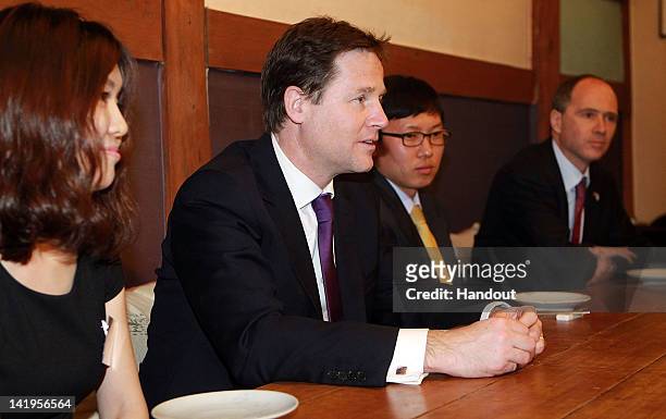 In this handout image provided by Yonhap News, Britain's Deputy Prime Minister Nick Clegg meets North Korea defected students living in South Korea...