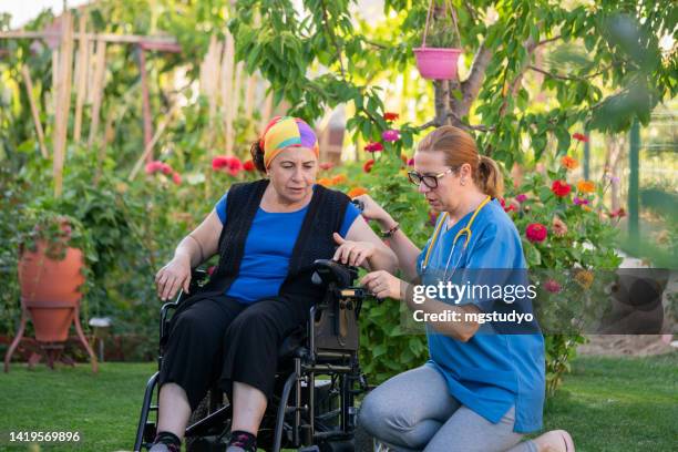 nurse teaches patient to use electric wheelchair. - motorized wheelchair stock pictures, royalty-free photos & images