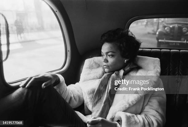 American actress and singer, Eartha Kitt riding in a black cab, London, 24th January 1957. Original Publication: Picture Post - 8817 - The Heart Of...