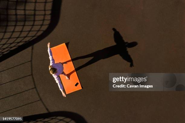 woman practicing yoga, aerial view - digital detox stock pictures, royalty-free photos & images