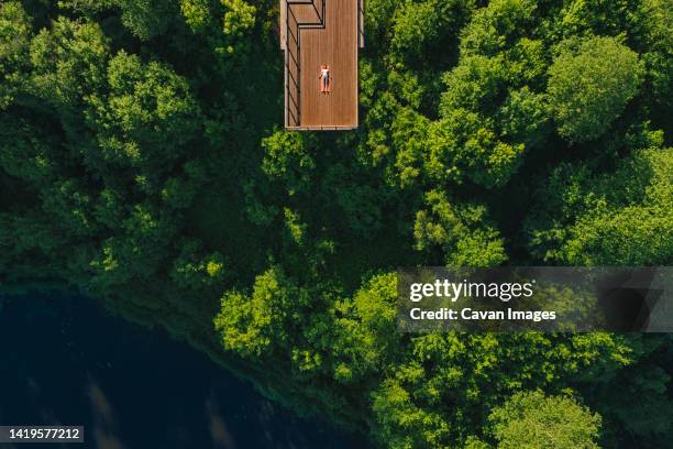 young woman doing yoga on the balcony - latvian woman stock pictures, royalty-free photos & images