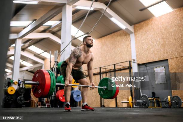 guy exercising in the cross training facility - deadlift stock pictures, royalty-free photos & images