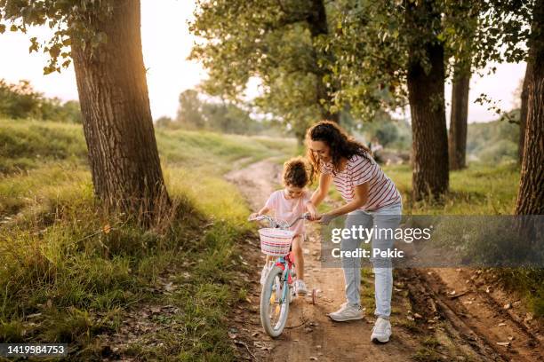 nehmen wir dieses fahrrad für eine fahrt - bicycle daughter stock-fotos und bilder