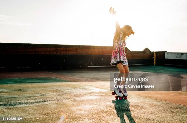 girl in a sequin dress dancing in her roller boots at sunset - sparkle children stock pictures, royalty-free photos & images