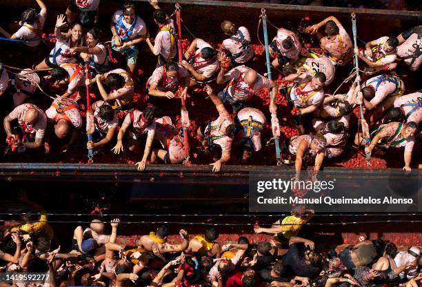 Revellers enjoy the atmosphere in tomato pulp while participating the annual Tomatina festival on August 31, 2022 in Bunol, Spain. The world's...