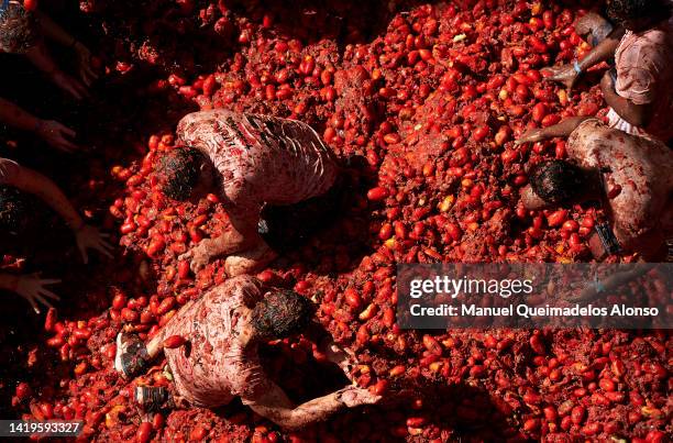 Revellers enjoy the atmosphere in tomato pulp while participating the annual Tomatina festival on August 31, 2022 in Bunol, Spain. The world's...