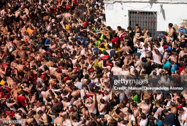 Revellers enjoy the atmosphere in tomato pulp while participating the annual Tomatina festival on August 31, 2022 in Bunol, Spain. The world's...