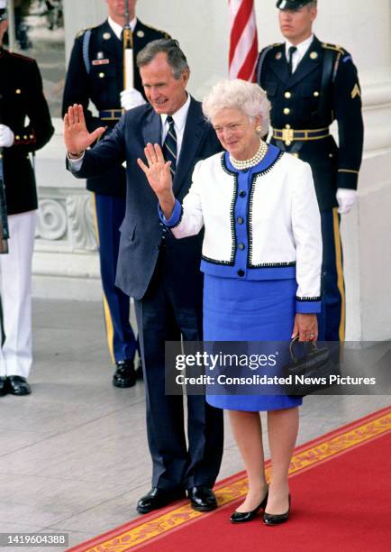 View of US President George HW Bush and First Lady Barbara Bush as they wave on the White House's North Portico, Washington DC, June 3, 1990. They...