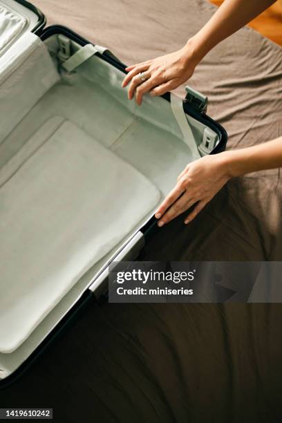 anonymous woman preparing an empty suitcase - open suitcase stock pictures, royalty-free photos & images