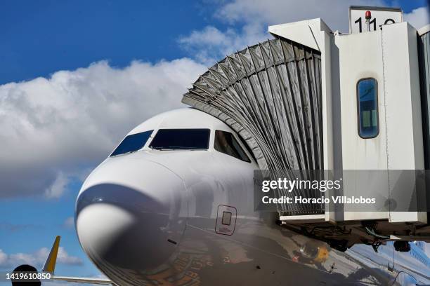 Vueling Airbus A321 is attached to the Passenger Boarding Bridge before getting ready to depart in Humberto Delgado International Airport on August...