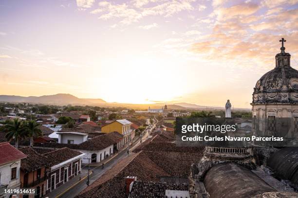 city and a cathedral during sunset - nicaragua stock pictures, royalty-free photos & images