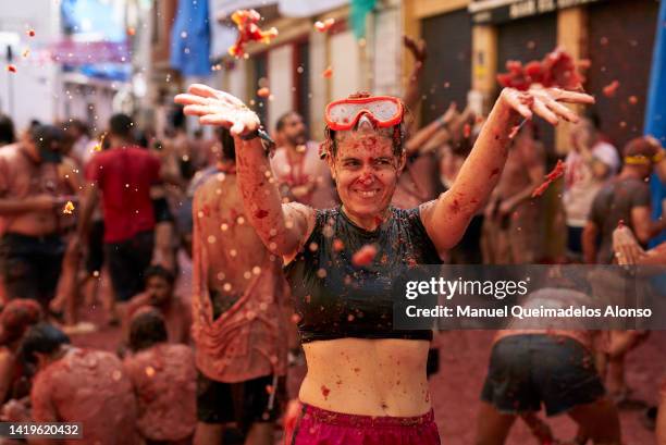 Revellers enjoy the atmosphere in tomato pulp while participating the annual Tomatina festival on August 31, 2022 in Bunol, Spain. The world's...