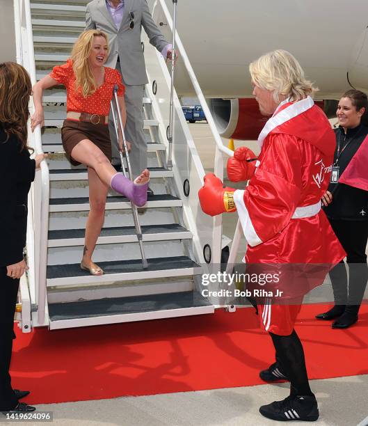Virgin Group Founder Sir Richard Branson welcomes actress Virginia Madsen and her injured foot to Chicago's O'Hare International Airport, May 25,...