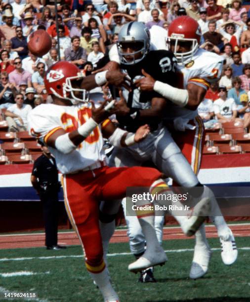 Raiders WR Calvin Muhammad is double-teamed by Chiefs Deron Cherry and Lloyd Burruss during game action at Los Angeles Raiders vs. Kansas City...