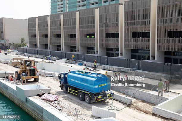 Construction workers are seen building new apartment blocks at the Al Muneera development during a media tour organized by Aldar Properties PJSC, Abu...