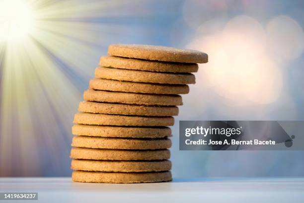 heap of round cookies illuminated by sunlight. - shortbread stock pictures, royalty-free photos & images