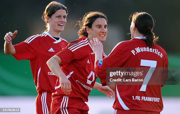 Birgit Prinz of Frankfurt celebrates with team mates Kerstin Garefrekes and Pia Wunderlich after scoring her teams second goal during the Birgit...