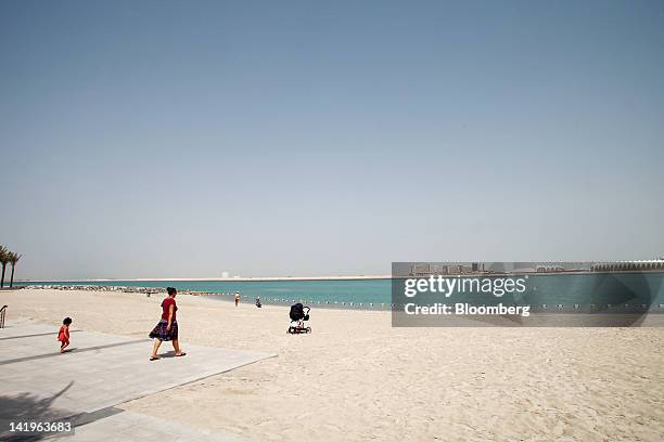 Visitors are seen on the beachfront at the Al Muneera development during a media tour organized by Aldar Properties PJSC, Abu Dhabi's biggest real...