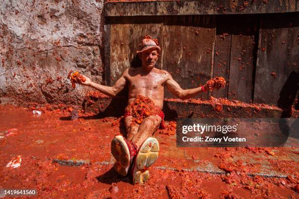 Reveler lays in tomato juice and pulp during the Tomatina festival on August 31, 2022 in Bunol, Spain. The world's largest food fight festival, La...