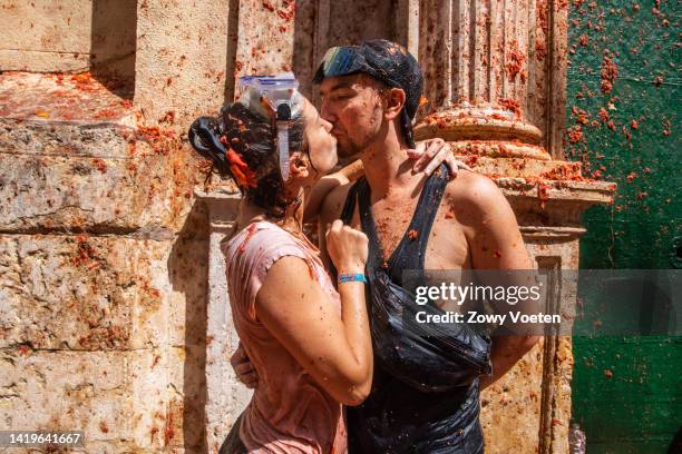 Couple kiss during the Tomatina festival on August 31, 2022 in Bunol, Spain. The world's largest food fight festival, La Tomatina, consists of...