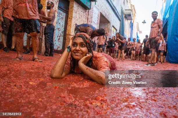 Reveler lays is tomato pulp during the Tomatina festival on August 31, 2022 in Bunol, Spain. The world's largest food fight festival, La Tomatina,...