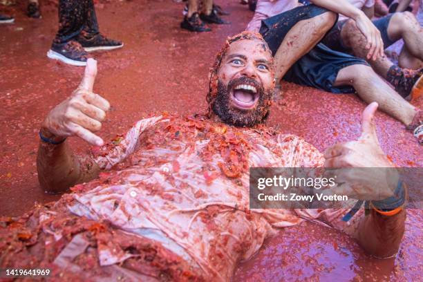 Reveler lays is tomato pulp during the Tomatina festival on August 31, 2022 in Bunol, Spain. The world's largest food fight festival, La Tomatina,...