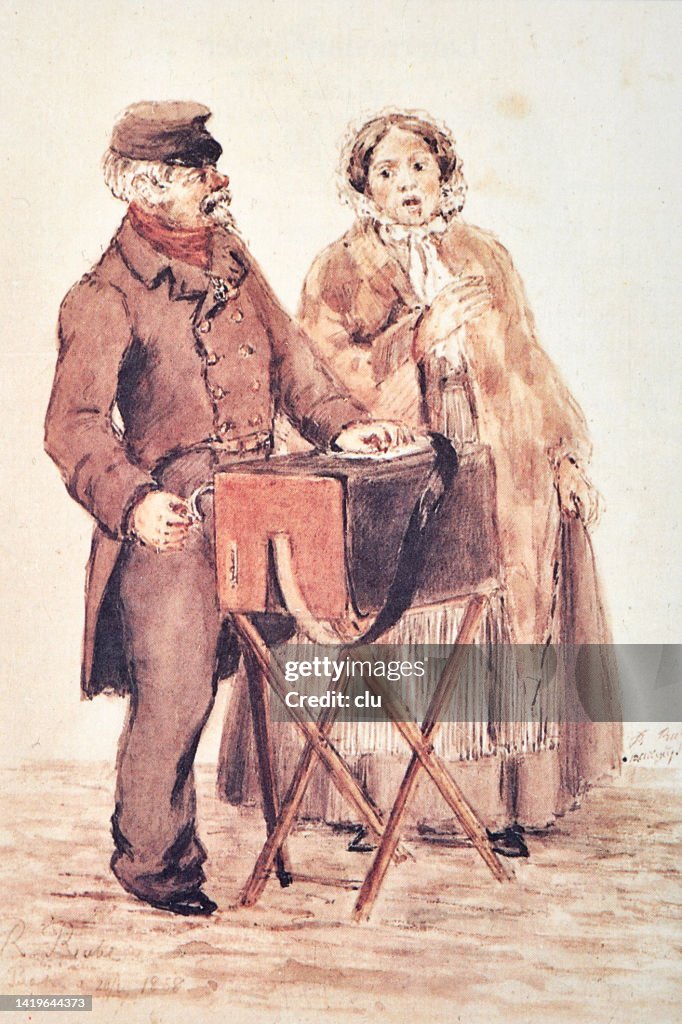 Organ grinder man with his wife performing on a street