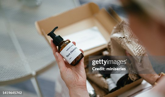 Anonymous Woman Holding a Gift Box and Looking at Beauty Cosmetics Products Inside (Copy Space) Anonymous Woman Holding a Gift Box and Looking at Beauty Cosmetics Products Inside (Copy Space)
